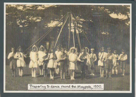 Black & white photograph of children around a maypole | unknown